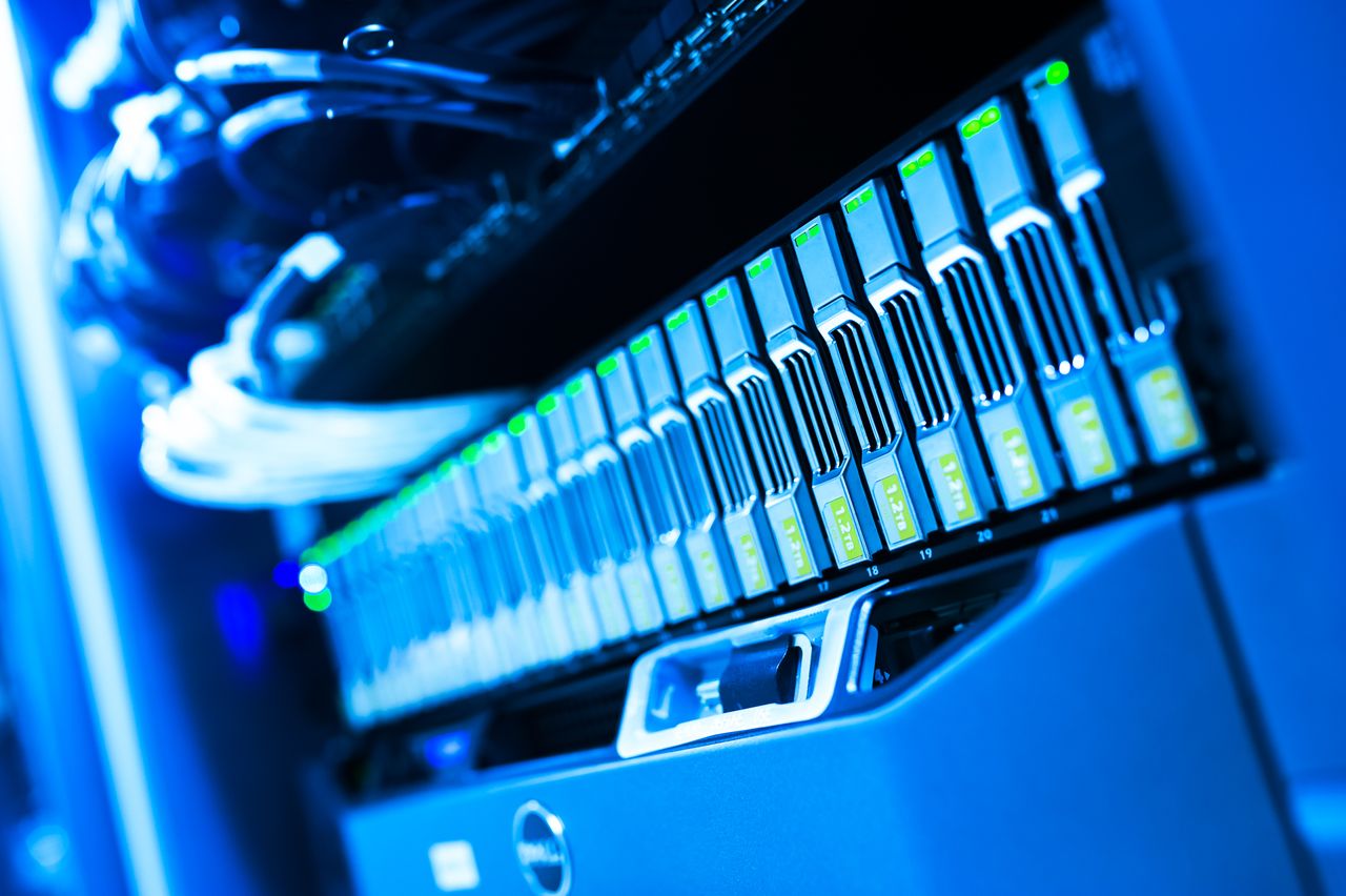Pourquoi avoir un site Internet pour son entreprise ? A detailed view of a blue lit computer server rack in a data center showcasing technology and hardware.